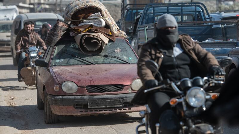 Syrian refugees leave their homes in Idlib with the few belongings they have left. Photograph:  Burak Kara/Getty Images