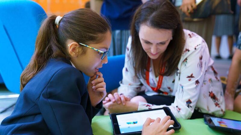 Joanne Dunstan, a teacher at Repton Abu Dhabi, with a pupil at a recent Apple plaque giving ceremony