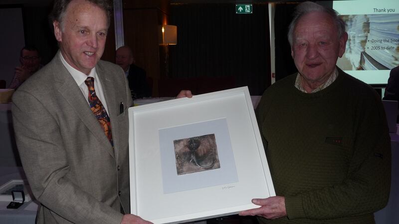 Irish Specimen Fish Committee chairman Robert Rosell  presenting a framed picture to Hugh O’Rorke for his long service as  auditor