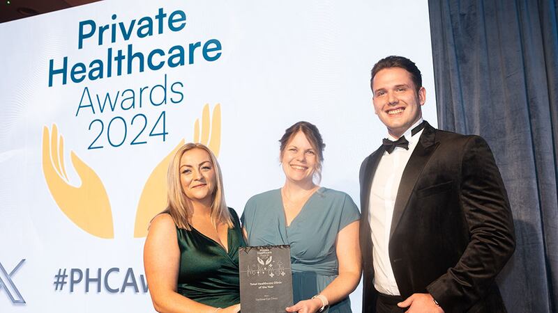 Lana Kane, managing director of Medforce, presents the total healthcare clinic of the year award to Joanna Melia and Reid Gardiner, Optilase Eye Clinic
