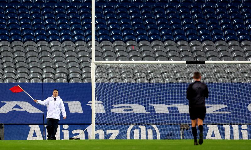 An umprire waves a red flag to signal a two-point score during the Interprovincial Series semi-final between Munster and Ulster last October. Photograph: James Crombie/Inpho