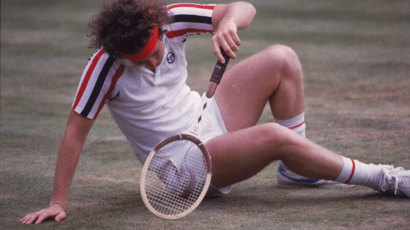 John McEnroe slips while playing  Björn Borg during the 1980 Wimbledon final. Photograph: Fox Photos/Hulton Archive/Getty Images