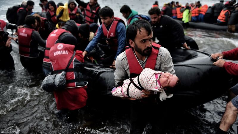 Migrants come ashore    on the Greek Island of Lesbos after crossing the Aegean Sea from Turkey in October, 2015. Photograph: Aris Messinis/AFP/Getty