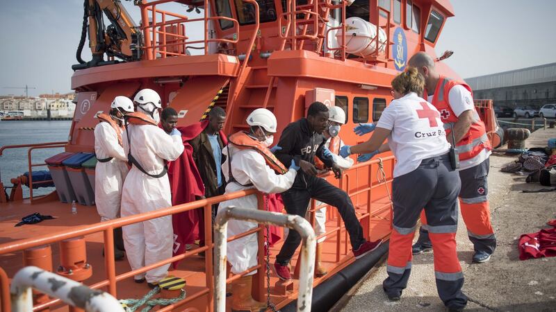 A migrant is helped by Red Cross volunteers to disembark after 143 Moroccans and nine sub-Saharans were rescued in the waters of the Strait of Gibraltar in June. Photograph: Marcos Moreno/AFP/Getty Images