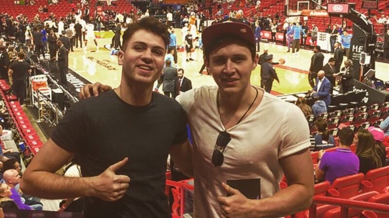 Eamon Donoghue, right, with his friend Colin Brennan watching a Miami Heat basketball game at the American Airlines Arena, Miami, Florida.