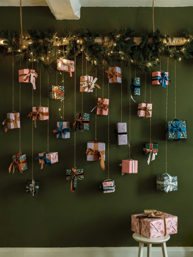 Small gifts: Advent calender by Neptune featuring small presents suspended from a branch.