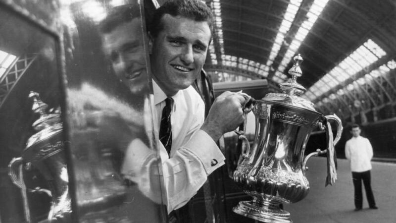 Noel Cantwell holds the FA Cup trophy after he captained Manchester United to victory in the 1963 final against Leicester City. Photograph: Getty Images