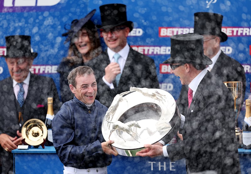 Jockey Wayne Lordan and trainer Aidan O'Brien celebrate with the trophy after Lambourn's win in the Epsom Derby. Photograph: Harry Murphy/Getty Images