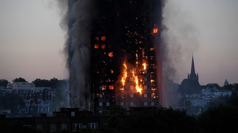 Flames and smoke billow as firefighters deal with the fire. Photograph: Toby Melville/Reuters