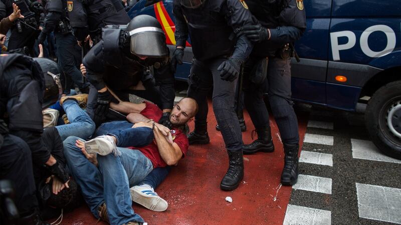 People clash with Spanish police officers outside the Ramon Llull polling station in Barcelona. Photograph: Fabio Bucciarelli/AFP/Getty Images