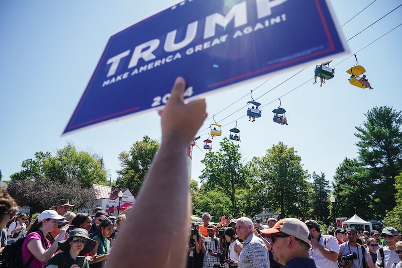 A Donald Trump supporter holds a sign as former US vice-president Mike Pence greets fairgoers at the Iowa State Fair in Des Moines last Friday. Photograph: Haiyun Jiang/New York Times