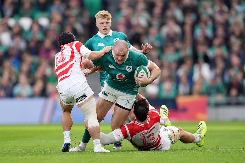 Ireland's Jacob Stockdale is tackled by Japan's Kippei Ishida (left) and Dylan Riley (right). Photograph: Niall Carson/PA