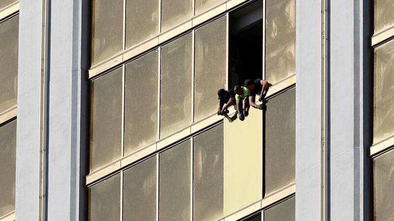 Workers board up a broken window at the Mandalay Bay hotel, where Stephen Paddock conducted his mass shooting on October 6th. Photograph: Chris Wattie/Reuters
