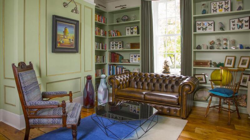 In the livingroom, the walls are painted pistachio green. Photograph: Anthony Woods