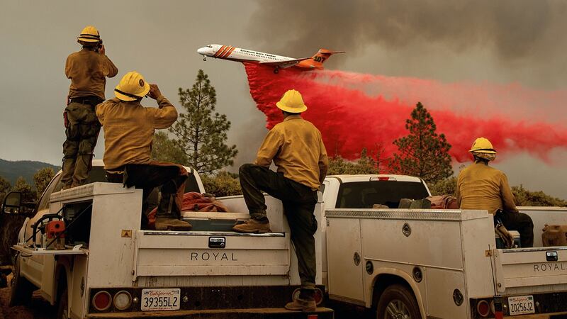 Firefighters watch as an air tanker drops retardant while battling the Ferguson fire in the Stanislaus National Forest, near Yosemite National Park,  on July 21st, 2018. Photograph: Noah Berger/AFP/Getty Images