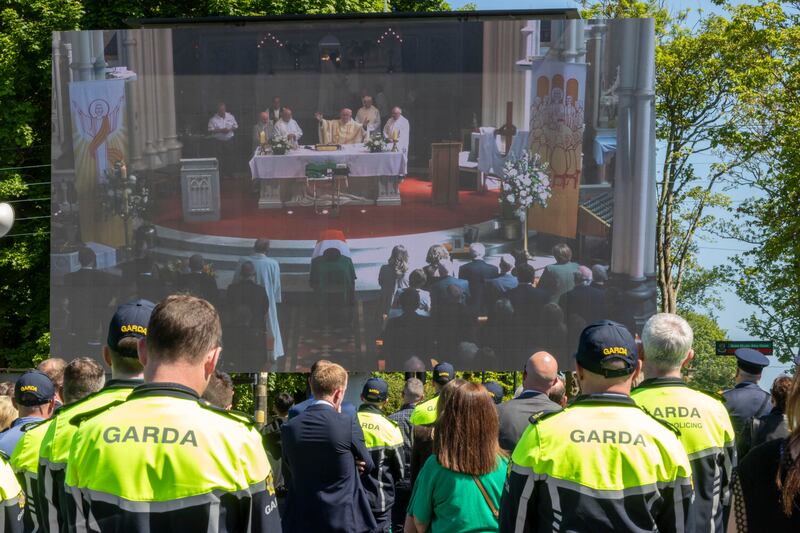 Mourners watch the funeral of Garda Kevin Flatley on screens outside at St Peter and Paul’s Church, Balbriggan. Photograph: Tom Honan