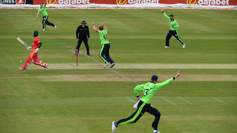 Harry Tector (bottom) celebrates after his direct hit ran out Zimbabwe’s Tadiwanashe Marumani during the game in Clontarf. Photograph: Seb Daly/Sportsfile