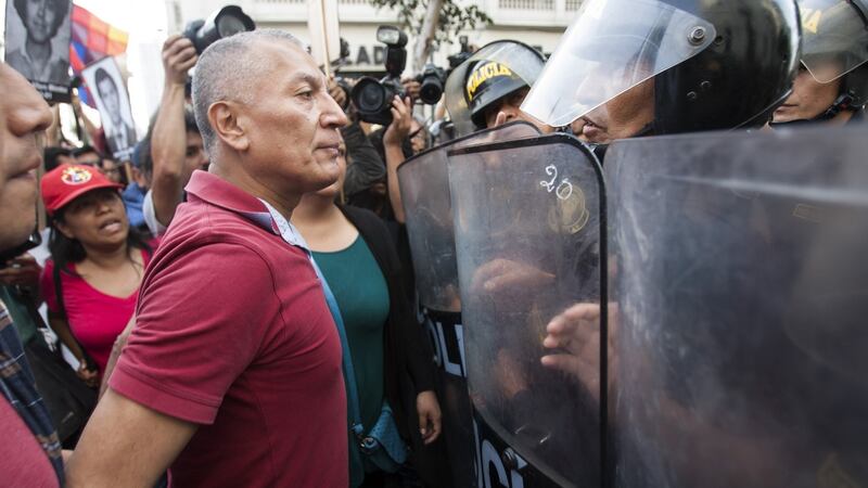 Riot police officers block the passage of protesters during a demonstration against the pardon for ex-president Alberto Fujimori, in Lima, Peru, on Christmas Day. Photograph: Eduardo Cavero/EPA