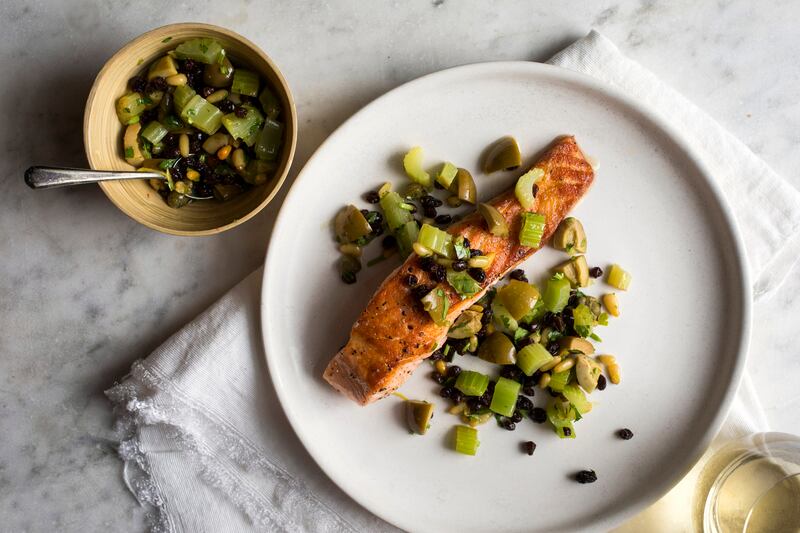 Yotam Ottolenghi’s salmon: pan-seared salmon with celery, olives and capers. Photograph: Andrew Scrivani/NYT
