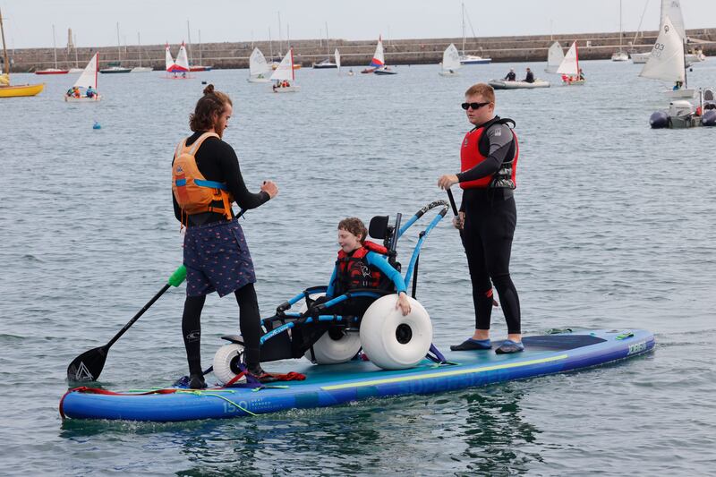Matthew Bernard and Josh O’Brien of Active Connections with Morgan on a Mega SUP. Photograph: Alan Betson