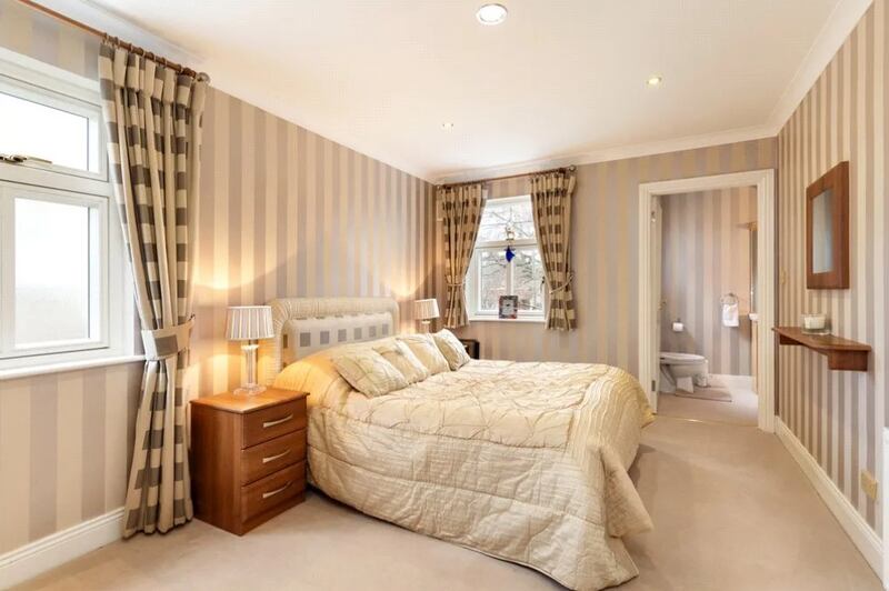Upstairs are five bedrooms off the large first-floor landing, four doubles and a single, two of them en suite, one with a wash-hand basin. 
