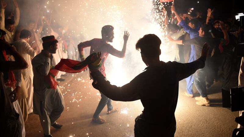 Supporters of Imran Khan celebrate in Karachi on Thursday, a day after the general election. Photograph: Rizwan Tabassum/AFP/Getty Images