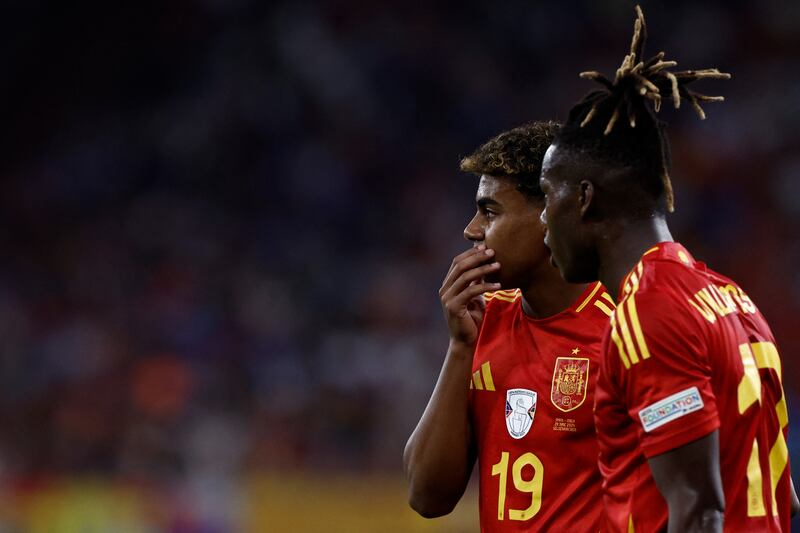 Midfielder Nico Williams speaks with Lamine Yamal during the UEFA Euro 2024 Group B football match between Spain and Italy at the Arena AufSchalke. Photograph: Kenzo Tribouillard/AFP via Getty Images