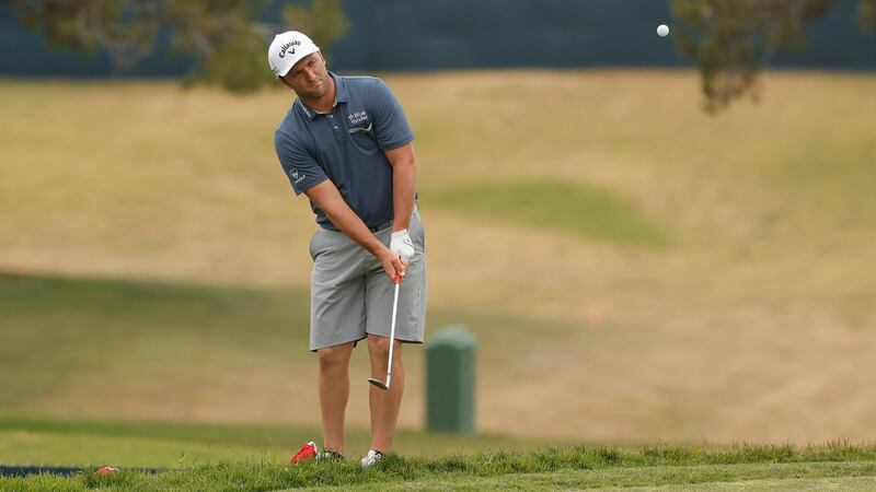 Jon Rahm practices on the chipping green. Photo: Ezra Shaw/Getty Images