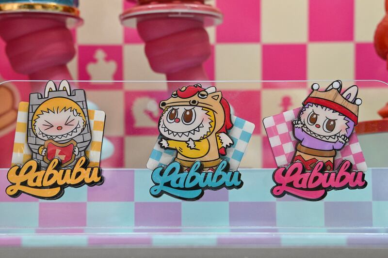 Stickers featuring Labubu figures at a Pop Mart shop in Beijing. A four-foot-tall sculpture of the viral plush toy character sold for $170,000. Photograph: ADEK BERRY/AFP via Getty Images