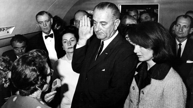 Lyndon Johnson being sworn in on Air Force One after John F Kennedy's assassination.