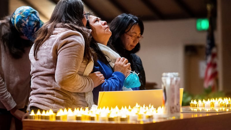 Lidia Steineman, who lost her home in the Camp Fire, prays during a vigil for fire victims. Photograph: Noah Berger/AP