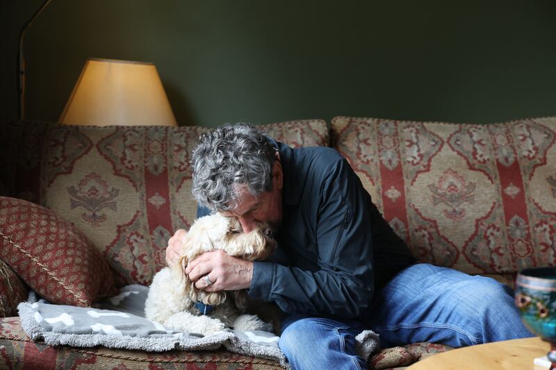 Charlie Bird and his dog, Tiger, on the couch at home in Ashford, Wicklow. Photograph: Nick Bradshaw