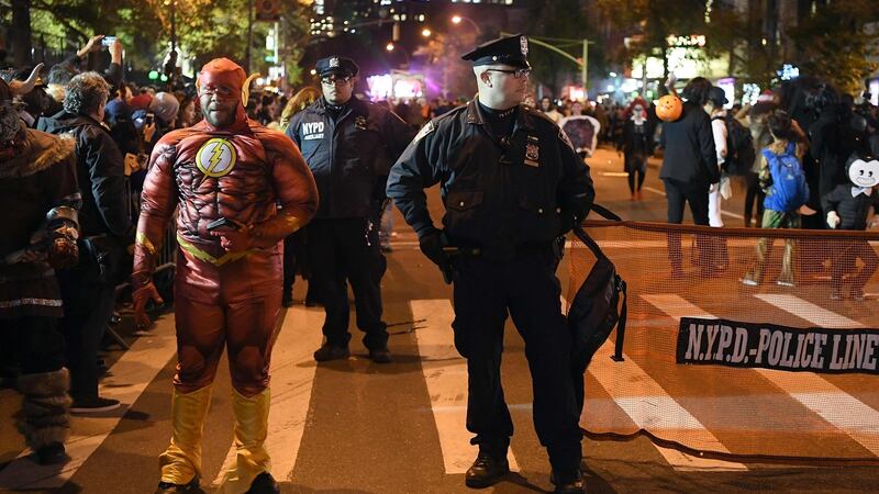 NYPD officers stand guard during the 44rd Annual Halloween Parade in New York. Photograph: Angela Weiss/AFP/Getty Images