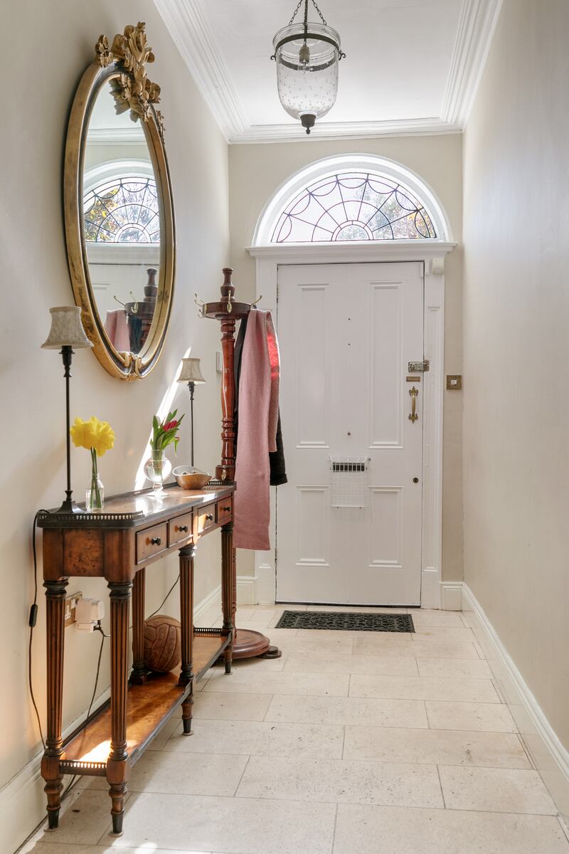 The hall features travertine tiles