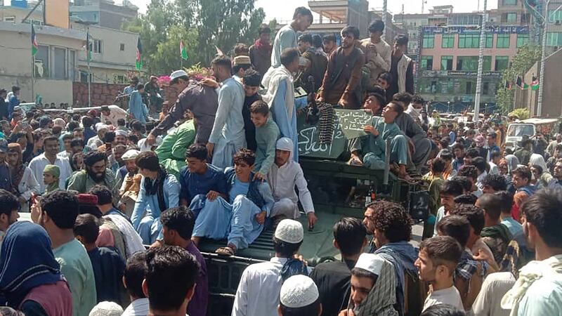 Taliban fighters and locals on an Afghan army Humvee in Jalalabad province on Sunday. Equipment has been abandoned by the army as the military situation deteriorates. Photograph: Getty