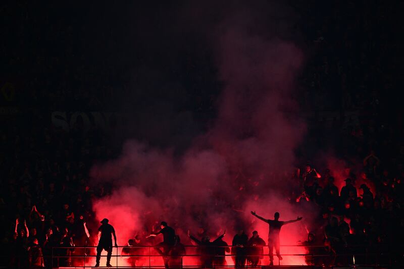 AC Milan fans lighting flares during the Champions League semi-final first leg match against Inter Milan at the San Siro. Photograph: Marco Bertorello/AFP