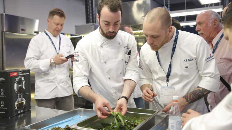 The UK and Ireland finalist, Killian Crowley, second left, preparing his dish for the final judging