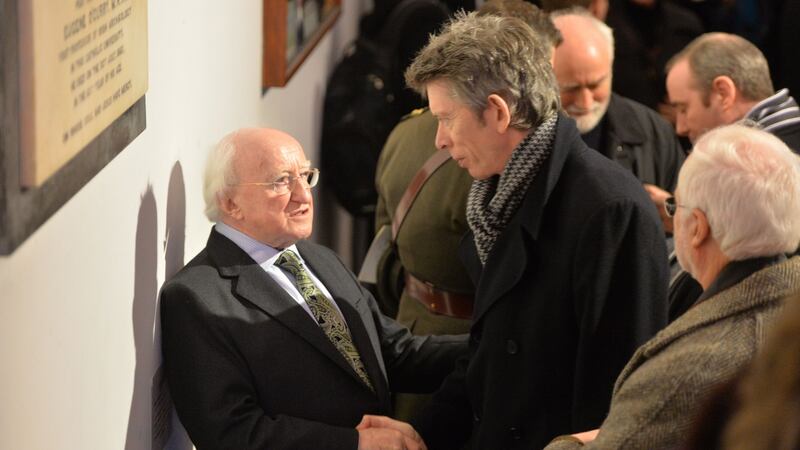 President Michael D Higgins with RTÉ presenter John Kelly at the funeral  of poet John Montague. Photograph: Alan Betson