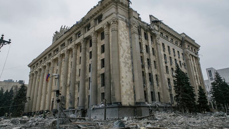 Ukrainian emergency service personnel gather outside the damaged City Hall building following shelling, in Kharkiv. Photograph: Pavel Dorogoy/AP Photo