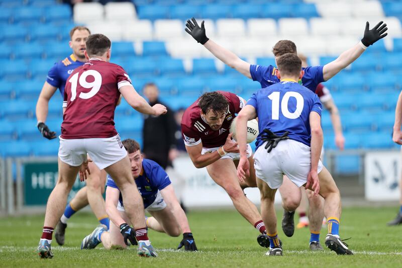 Westmeath's Andy McCormack is tackled by Jonathan Carlin with Tom Moran of Wicklow. Photograph: Bryan Keane/Inpho