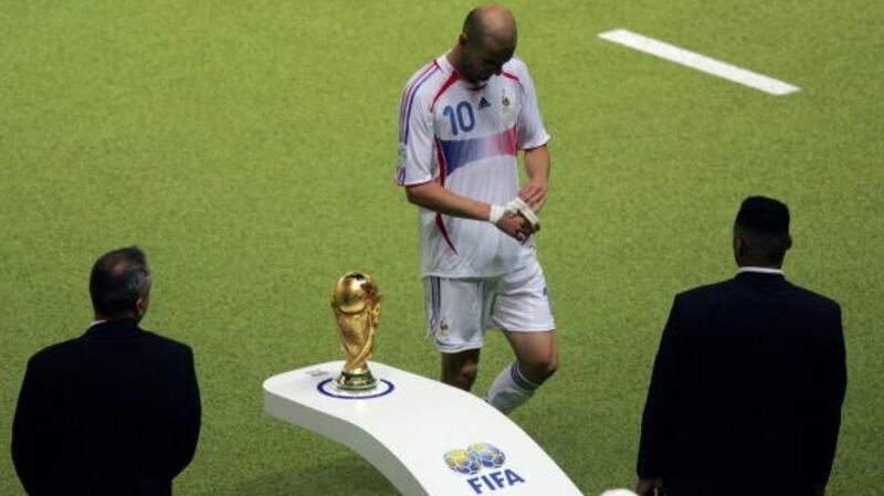 Zidane  walks past the World Cup trophy  after getting a red card for head-butting Materazzi. Photograph: Getty Images