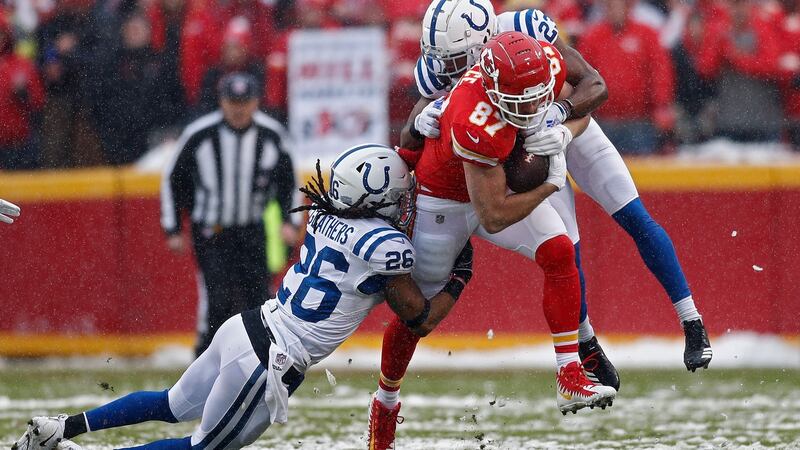 Colts players Kenny Moore II and Clayton Geathers try to tackle Travis Kelce. Photo: Larry W Smith/EPA