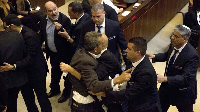 Israel’s Arab parliamentary bloc and Knesset members scuffle with security after they held signs in protest during US vice president Mike Pence’s speech  in Israel’s parliament. Photograph:  Ariel Schalit/AFP/Getty Images