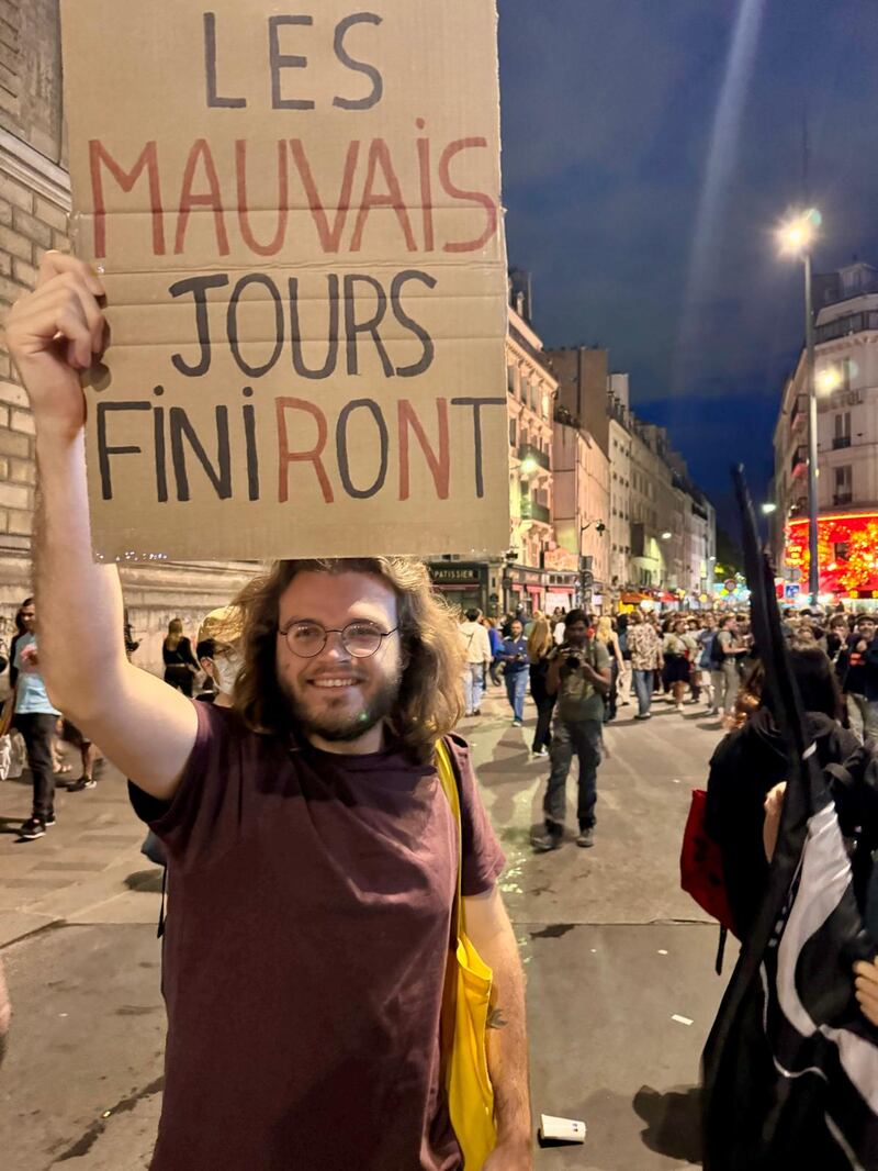 A young man holds up a placard saying 'The bad days will end' on the Place de la République on Sunday night. Photograph: Susanna Schrobsdorff