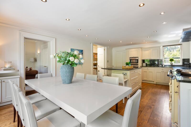 The kitchen is fitted with hand-painted units, marble worktops and an Aga and has a separate pantry
