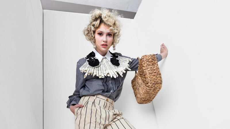 Stripe trousers, €750, and gingham blouse €675, Samui, Cork; paper manuscript fan collar €65, Mary Ginnifer Designs; basket bag, €38, Topshop,  Cork; earrings €35, Diamond Buyers Club, Sheena Boutique, Cork.