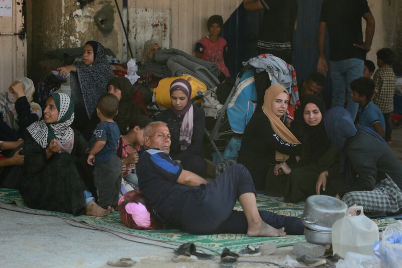 Families forced to flee following an Israeli army evacuation order for parts of Khan Younis, including the Al-Mawasi 'humanitarian zone', rest in the shade in another area of the southern Gaza Strip city on Tuesday. Photograph: Bashar Taleb/AFP via Getty Images