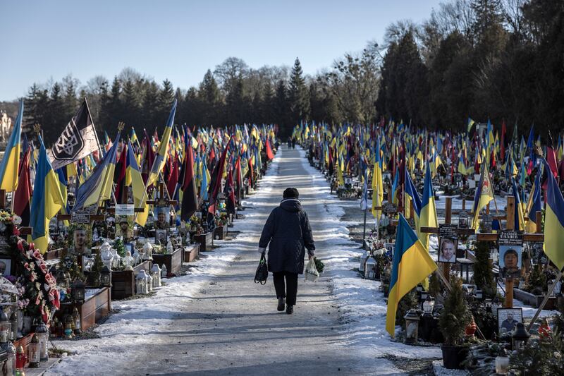 A woman walks between graves of Ukrainian soldiers killed in combat since Russia’s February 2022 invasion of the country. Photograph: Finbarr O’Reilly/The New York Times
                      