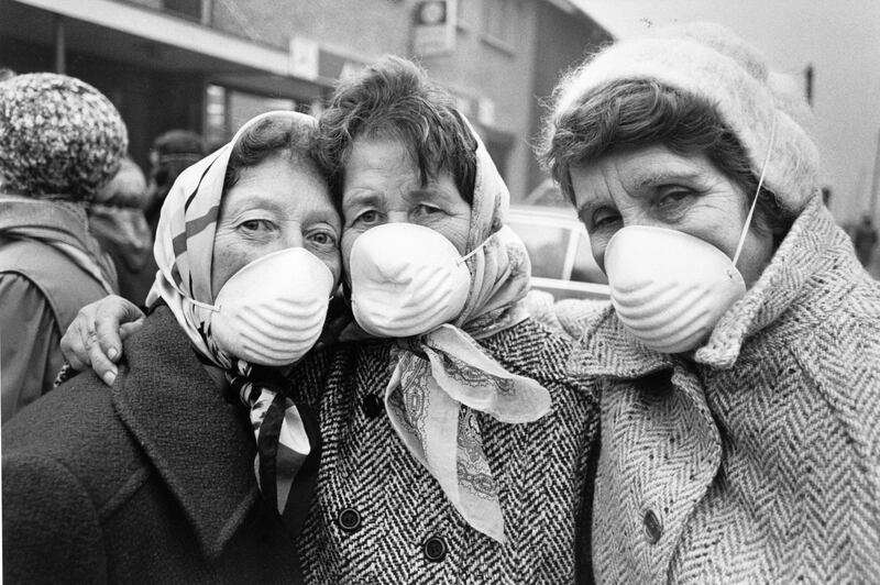 Pauline O'Hara (left) Bridget O'Hara, (centre) and Mary Nolan donned protective masks distributed by local GP Dr Conor O'Hanlon in protest at government inactivity in November 1988 over smog levels in Dublin.   Photograph: Peter Thursfield