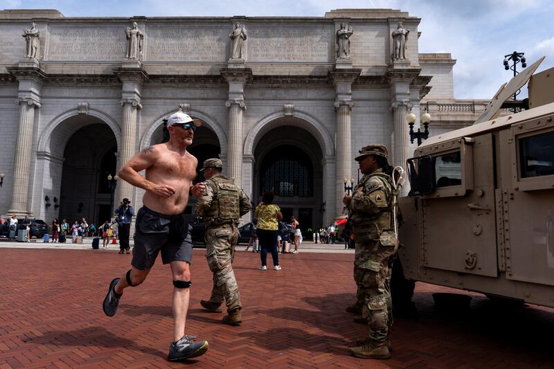A jogger who said “thank you!” as he passed members of the National Guard outside Union Station in Washington, DC. Photograph: Kent Nishimura/The New York Times
                      